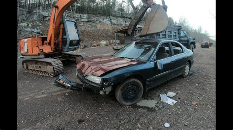 Smashing car with an excavator 